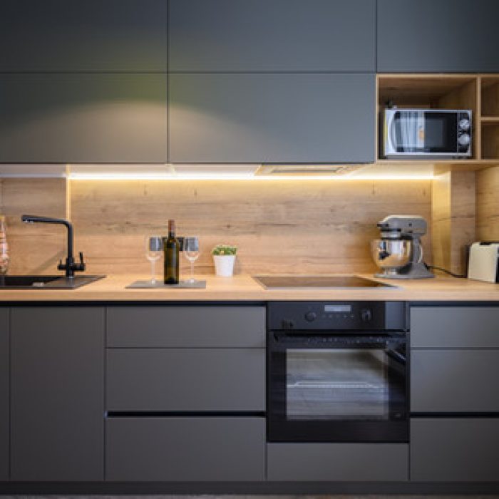 Gray Kitchen Doors with light wood backsplash (1)